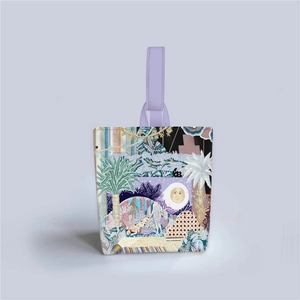 Close-up of artistic embroidered fabric showing floral and moon patterns on the handbag