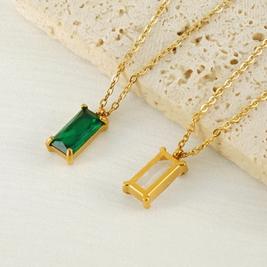 Gold plated stainless steel square zircon pendant necklace on a stone background