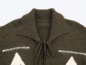 Detail of olive green knit cardigan with white triangle jacquard and tie-up collar