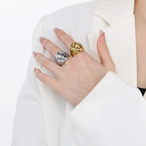 Chic geometric lava texture rings in gold and silver finish shown on a model's hand