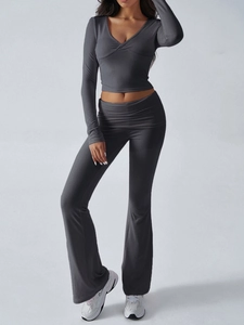 Detail of dark grey knit set featuring V-neck cropped top and high-waisted flare pants