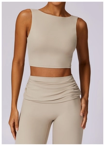 Detail view of high-waisted yoga leggings with unique crossover pleated waistband design