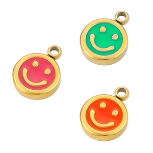 Detailed macro of colorful enamel smiley face charms in gold stainless steel finish