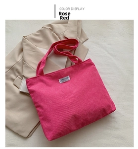 Detailed texture of rose red corduroy tote bag with Fashion Instinct woven label