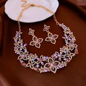 Exquisite hollow flower jewelry set with crystals on elegant brown satin background