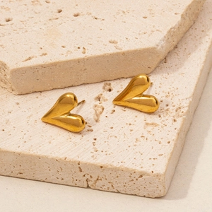 Detailed view of 18K gold plated 304 stainless steel heart earrings on stone surface