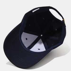 Internal view of navy blue cotton cap showing reinforced lining and adjustable metal buckle