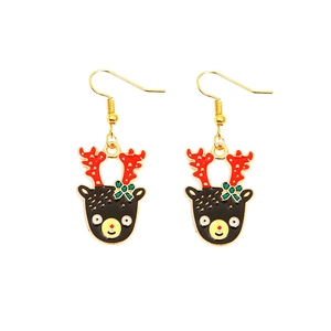 Detail of Christmas reindeer earrings with red antlers and festive green bow decorations