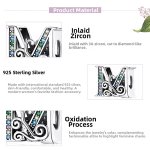 Close-up of 925 sterling silver letter M charm with colorful pavé cubic zirconia stones