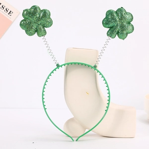 Detail of glittery green shamrocks on silver springs for St. Patrick's Day headband