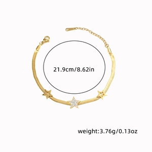 Close-up of golden flat snake chain bracelet featuring three star charms with zircons