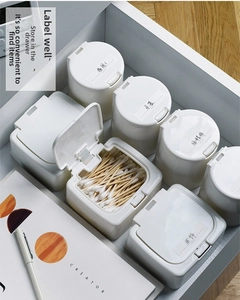 Mini plastic storage boxes with lids neatly organized in a drawer for home storage
