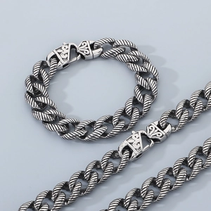 Detail of vintage twisted rope chain with totem engraved clasp on silver steel jewelry