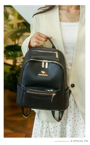 Close-up of black PU leather backpack with gold hardware and kangaroo logo detail