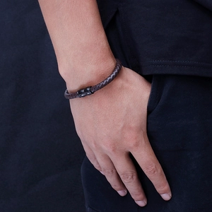Men's dark brown braided leather bracelet with black magnetic clasp on wrist
