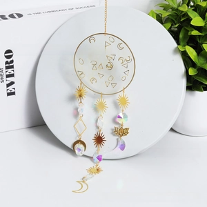 Detail of golden suncatcher with celestial moon pendants and faceted crystal beads