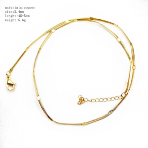 Detail of 45cm gold copper snake chain necklace with flat round charms and 5cm extension