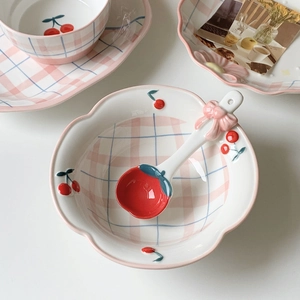 Ceramic cherry dinnerware set with pink checkered plates and bow-accented spoons