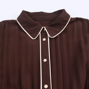 Deep brown midi dress featuring vertical pleats with a white trimmed lapel collar