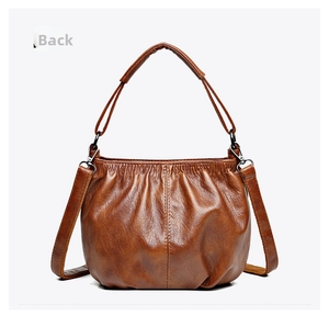 Detailed back view of a brown pleated handbag with soft texture and leather grain