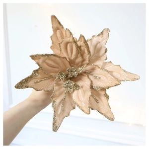 Detail of velvet champagne Christmas flower with gold glitter accents for holiday decor