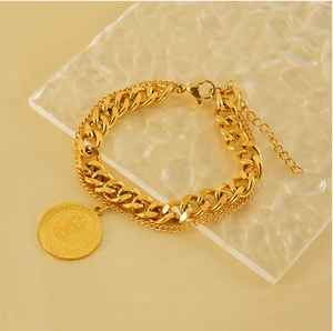 Close-up of double-layer gold titanium steel bracelet with Elizabeth II coin charm