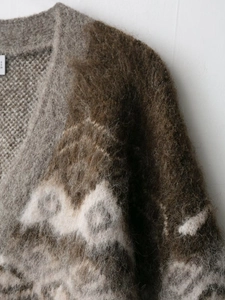 Macro shot of jacquard knit cardigan showing soft mohair texture and geometric pattern