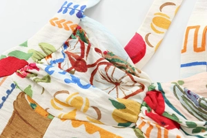 Macro shot of colorful illustrative print fabric with detailed woven texture and ruched design
