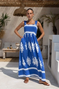 Close-up of bohemian blue floral dress featuring a shirred bust and thick shoulder straps