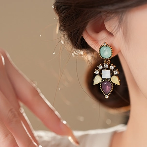 Vintage floral resin drop earrings with crystal accents on a model for a luxury look