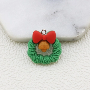 Detail of Christmas wreath pendant with red bow and gold bell for DIY accessories