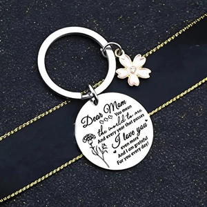 Stainless steel mother keychain with floral pendant on black leather texture