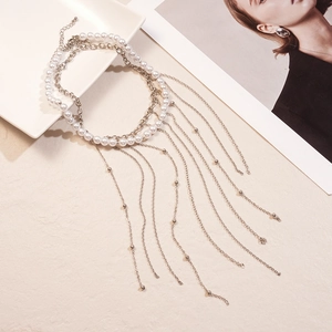 Detailed view of layered imitation pearl tassel necklaces with silver chains and lobster clasp