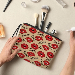 Portable makeup bag with red lips and text pattern, featuring top handle and black zipper