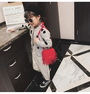 Close-up of a stylish red leopard print tassel crossbody bag for children's fashion