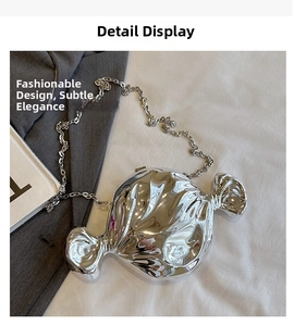 Detail of silver candy-shaped hard shell bag with metallic mirror finish and chain
