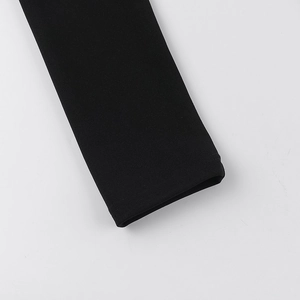 Macro shot of sleeve cuffs showing high-quality black knitted fabric texture