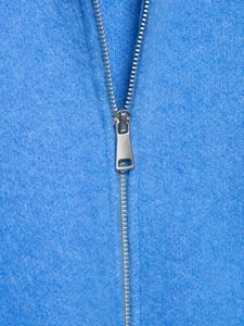 Close-up of premium silver metal zipper and blue knit fabric texture on jacket