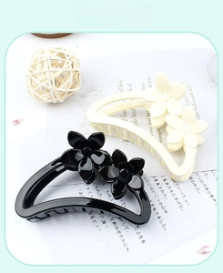 Set of black and beige floral hair claws with glossy finish and dual flower accents