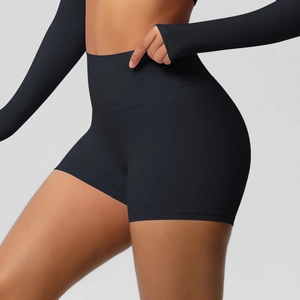 Detail showing the high-waisted compression fit and contouring of black yoga shorts
