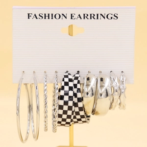 Detail view of 5-piece silver earrings set with various hoop styles and checkered designs