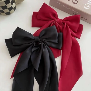 Elegant large satin bow hair clips in black and wine red with long flowing ribbons