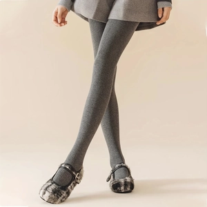 Close-up of grey vertical ribbed cotton leggings paired with fuzzy Mary Jane shoes