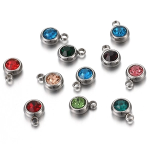 Close-up of colorful round crystal birthstone charms with stainless steel metal bases