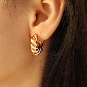 Chic hollow geometric gold and white enamel earrings in a twisted stripe design for women