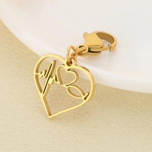 Golden heart pendant with medical heartbeat and stethoscope detail on a lobster clasp