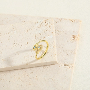Golden fish tail ring with evil eye blue drop oil and zircon accents on stone