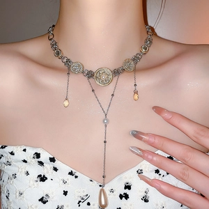 Macro view of rhinestone and pearl choker necklace with crystal fringe and teardrop pendant