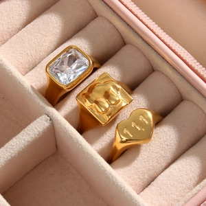 Golden rings set with white zircon and engraved heart ring in pink gift box