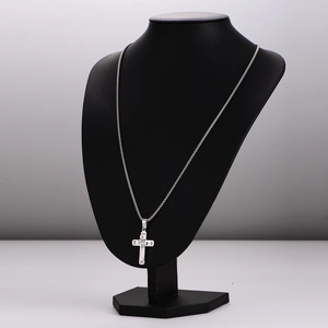 Silver stainless steel double layer cross necklace with diamonds on a black mannequin